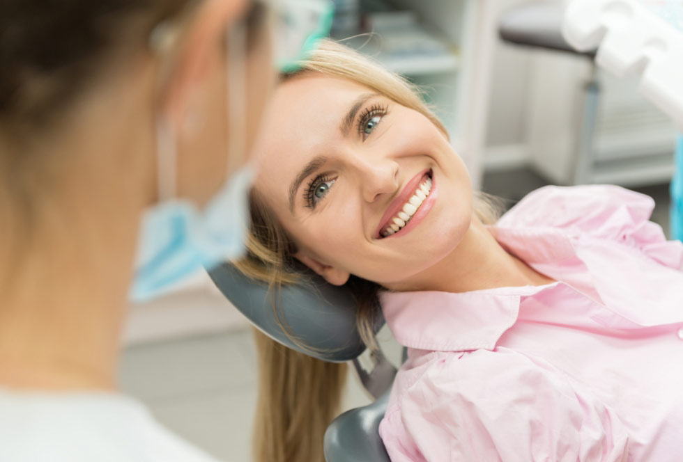 Woman smiling at her dentist